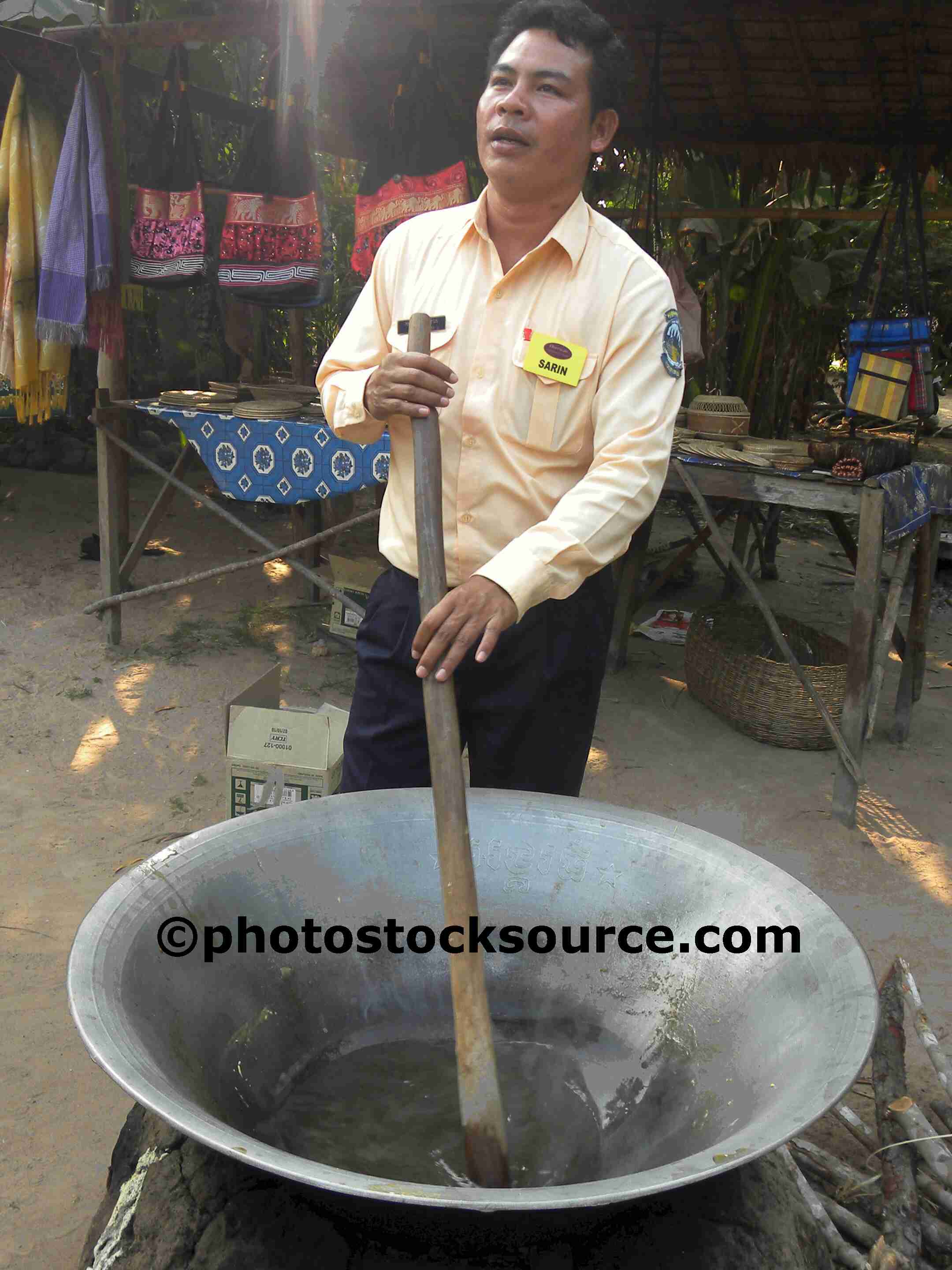 Photo of Man Stirring Pot by Photo Stock Source people, , Kampong