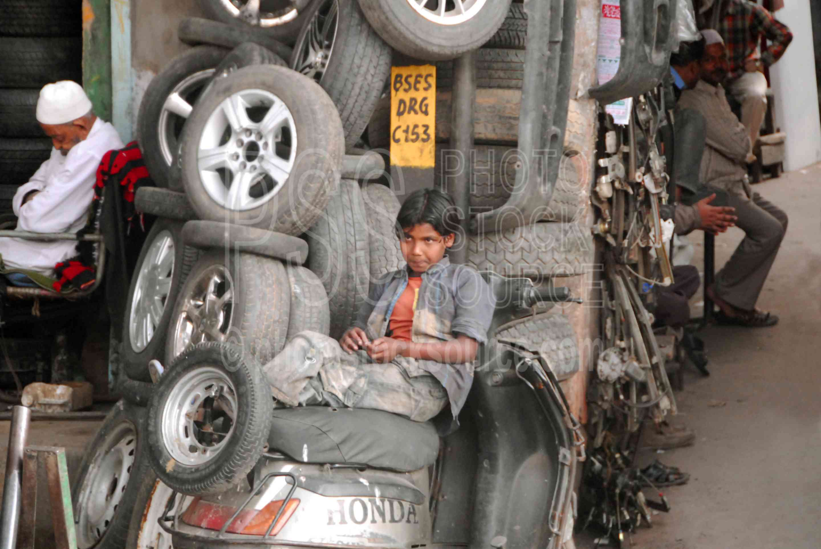 Boy at Tire Store,people,working,street,market,tires