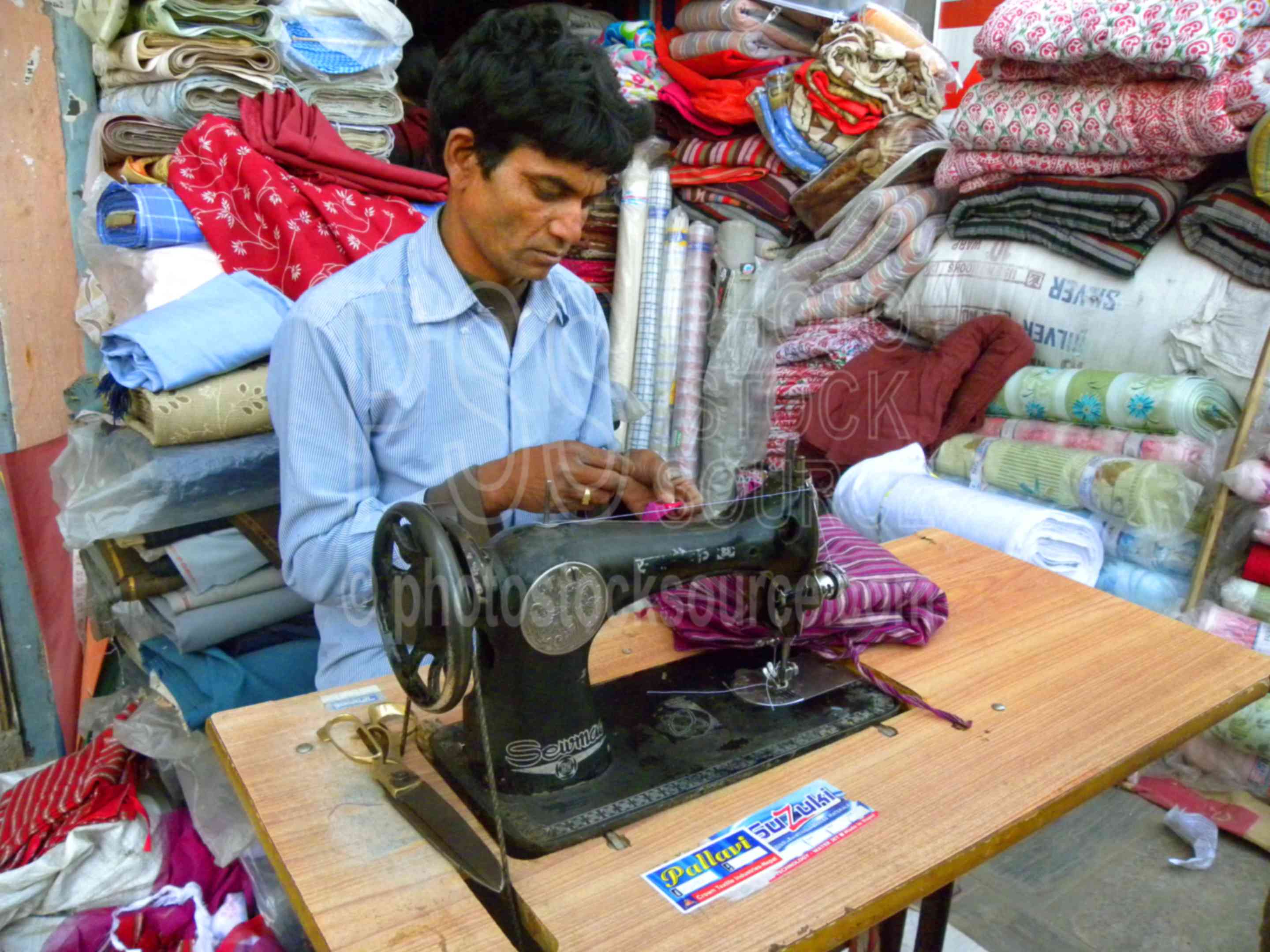 Photo of Man Sewing Fabric by Photo Stock Source people, New Baneshwor